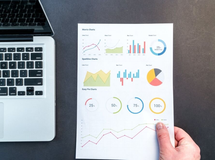 person holding chart and bar graph